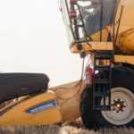 Rainwater Harvesting - A yellow and black combine harvester in a field