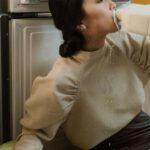 Declutter - Woman Drinking Milk Near Refrigerator