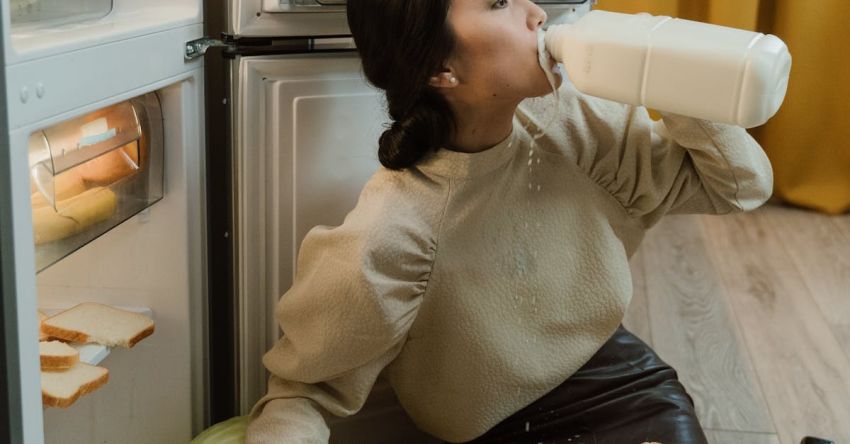 Declutter - Woman Drinking Milk Near Refrigerator