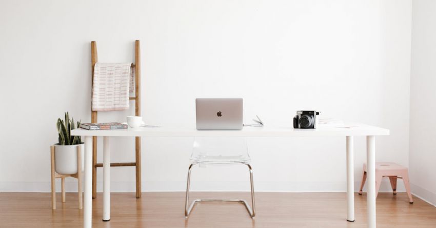 Minimalist Workspace - Silver MacBook on White Table