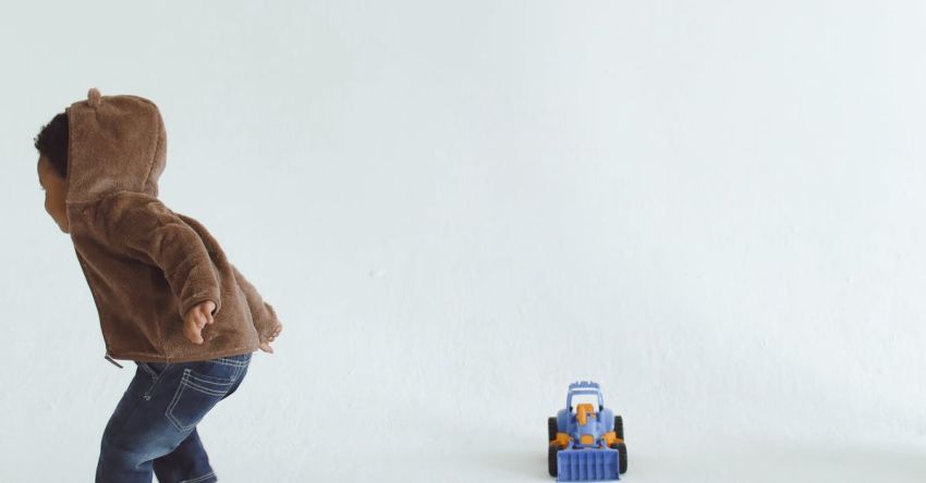 Indoor Activities - A Child Playing with a Mat of Colors