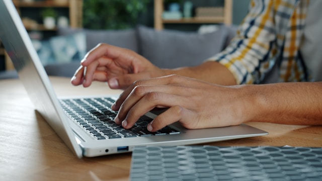 person-typing-on-a-laptop-computer-at-a-desk